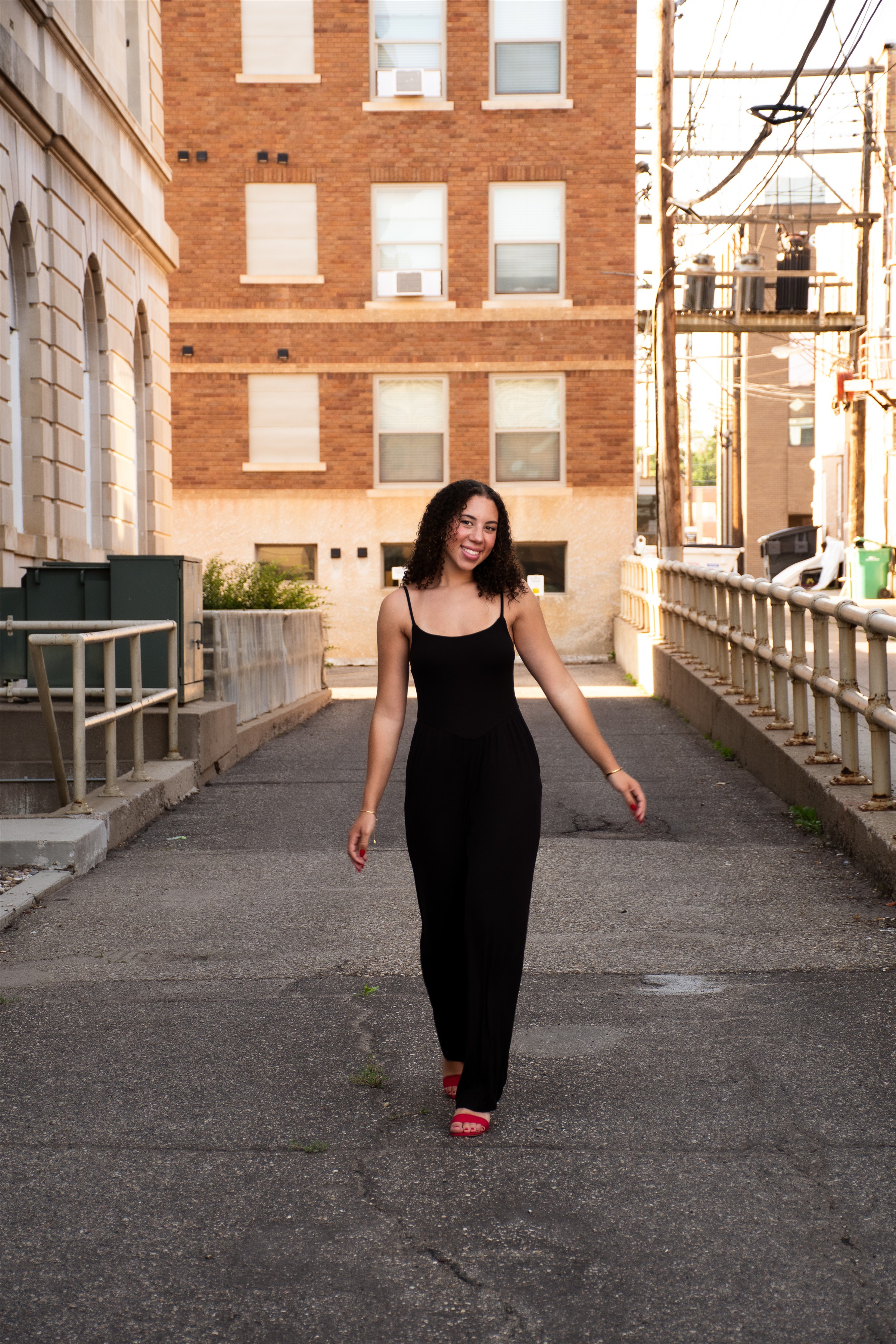 Woman in black dress, standing downtown 